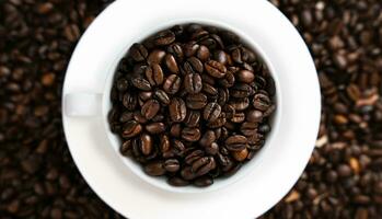 Coffee beans in a white cup on a coffee background. Banner. Top view. Close-up. Selective focus. photo