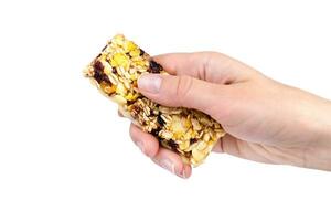 Woman's hand holding energy protein bar isolated on white background. Close-up. photo