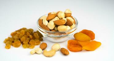 Healthy snack. Mix of dried fruits and nuts isolated on white background. Healthy food concept. Banner. Close-up. photo