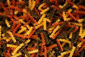 Tricolor fusilli paste spiral shape. Background of pasta. Top view. Close up. Selective focus. photo