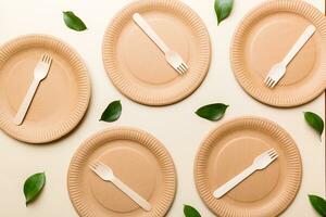 set of empty reusable disposable eco-friendly plates, cups, utensils on light white colored table background. top view. Biodegradable craft dishes. Recycling concept. Close-up photo