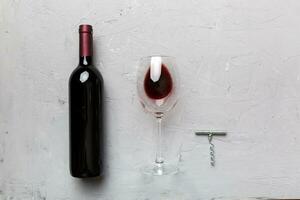 Flat lay composition with corkscrew, bottle of wine and elegant glass on colored table. Flat lay, top view wth copy space photo