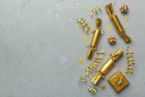 Christmas crackers with shiny confetti on color background, top view, copy space photo