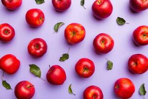 Many red apples on colored background, top view. Autumn pattern with fresh apple above view photo