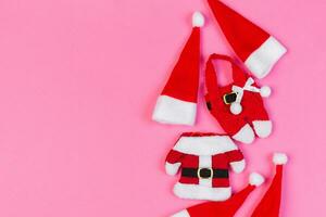 Top view red Santa hats on colorful background. Time for holiday concept with empty space for your design photo