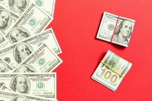 Heap of hundred Dollar Bills on colored background top view, with empty place for your text business money concept photo