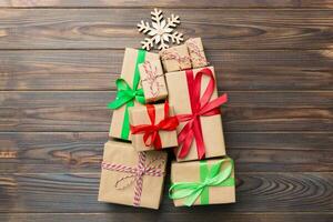 Christmas tree made of beautifuly wrapped presents on colored background, view from above. New Year gift box minimal concept with copy space photo
