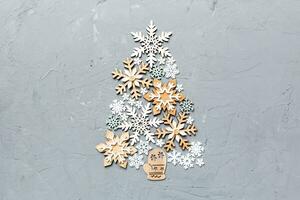 Christmas tree made from colored handmade ball decoration on colored background, view from above. New Year minimal concept with copy space photo