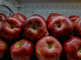 a pile of fresh red apples in a traditional market in jakarta. photo