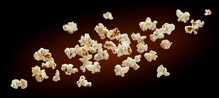 Popcorn isolated on black background. Falling or flying popcorn. Close-up photo