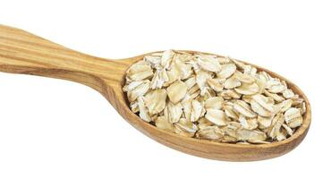 Oatmeal. Oat flakes in wooden spoon isolated on white background photo