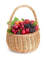 Different berries in basket on white background photo