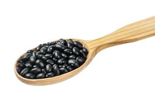 Black beans in wooden spoon isolated on white background photo