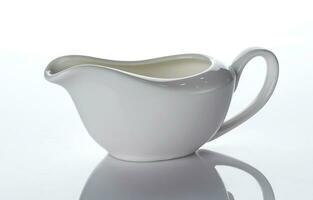 Empty ceramic creamer isolated on white background photo