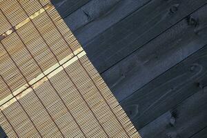 Bamboo mat on wooden table, top view photo