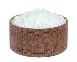 Sea salt in wooden bowl isolated on white background closeup top view photo