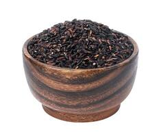 Black rice in wooden bowl isolated on white background photo