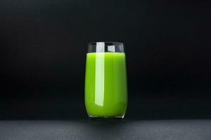 Organic green smoothie, apple juice on isolated on black background with copy space, fresh cocktail photo