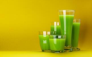 Organic green smoothie, apple juice on isolated on yellow background with copy space, fresh celery cocktail photo