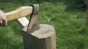 Wood chopping. Man hands using ice ax. Close-up shot. Slow motion. video