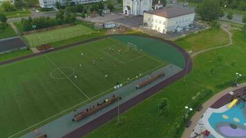 Moscow, 2017 - Drone flying around green soccer field. Football match in city park. Aerial view. video