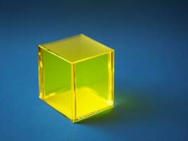 gold cube isolated on blue background. photo