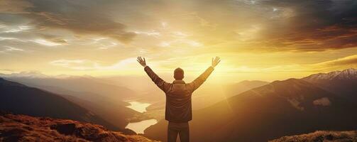 Positive man celebrating with arms raised up at Mountain landscape at sunset, Generative AI photo