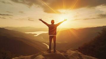 Positive man celebrating with arms raised up at Mountain landscape at sunset, Generative AI photo