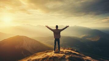 Positive man celebrating with arms raised up at Mountain landscape at sunset, Generative AI photo