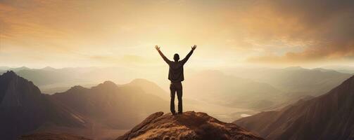 Positive man celebrating with arms raised up at Mountain landscape at sunset, Generative AI photo