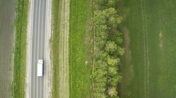 top view, aerial photos and road cars moving along the highway. Road and field top view.
