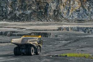 Dump truck in limestone mining, heavy machinery. Mining in the quarry. photo