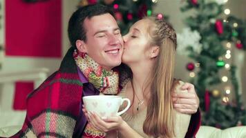 Young beautiful couple holding hands with a cup of cocoa video