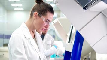 Close Up of a Female Research Scientist Using Micropipette to Mix Liquids in a Test Tube in a Modern Laboratory. video