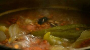 Soup of pepper and lentils boiling in a pot video