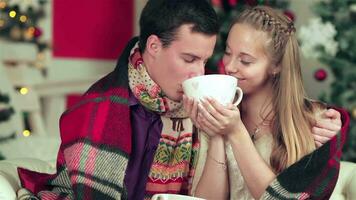 A loving couple holding cups and drinks at Christmas video