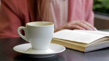 Book and a cup of coffee on the table video