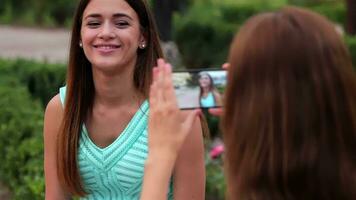 Two beautiful girlfriends make selfie photo video
