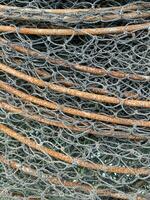 old rusty metal rod with fishing net photo