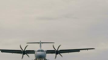 Turboprop passenger aircraft approaching landing, bottom view. Airplane in the sky. Travel and air transportation concept video