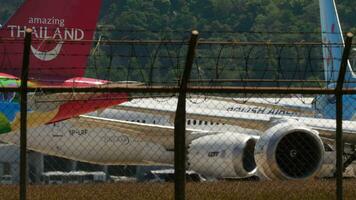 PHUKET, THAILAND FEBRUARY 10, 2023 Airplanes on the apron, taxiway. Busy aviation traffic, airfield. Boeing 787 Dreamliner of LOT taxiing at Phuket airport. Travel aviation concept video