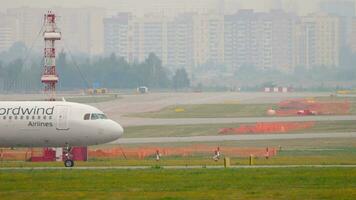 MOSCOW, RUSSIAN FEDERATION JULY 30, 2021 Commercial jet plane Airbus A321 of Nordwind taxiing. Airliner on the taxiway. Row of planes at the terminal. Busy Sheremetyevo airport, airfield video