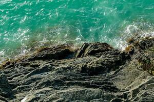 aerial view of the ocean and rocks near the shore photo