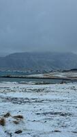 Frozen natural scenery in iceland with frosty cold landscape in nordic region, massive snowy mountains and lands. Winter wonderland roadside environment with highlands and cliffs. photo