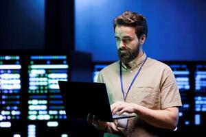 Specialist doing maintenance in server farm providing secure, scalable, and failsafe infrastructure for storing, computing, and analyzing large amounts of data generated by AI applications photo