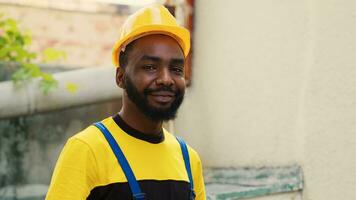 Revealing portrait shot of happy trained engineer with tablet checking refrigerant levels in condenser while using manometers to accurately measure the pressure in HVAC system photo