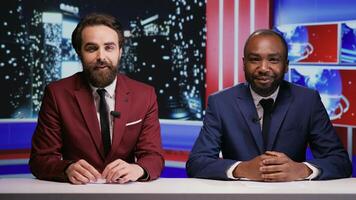 Diverse reporters host night talk show on international television network, creating reportage on breaking news with latest topics. Journalists team presenting entertainment and media segment. photo