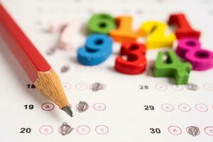 Math number and pencil on answer sheet paper, Education study testing learning teach concept. photo