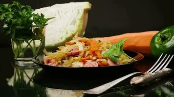 cooked fried cabbage with vegetables and sausages video