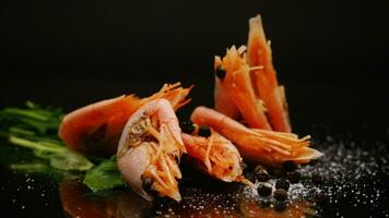boiled shrimp with spices on black background video